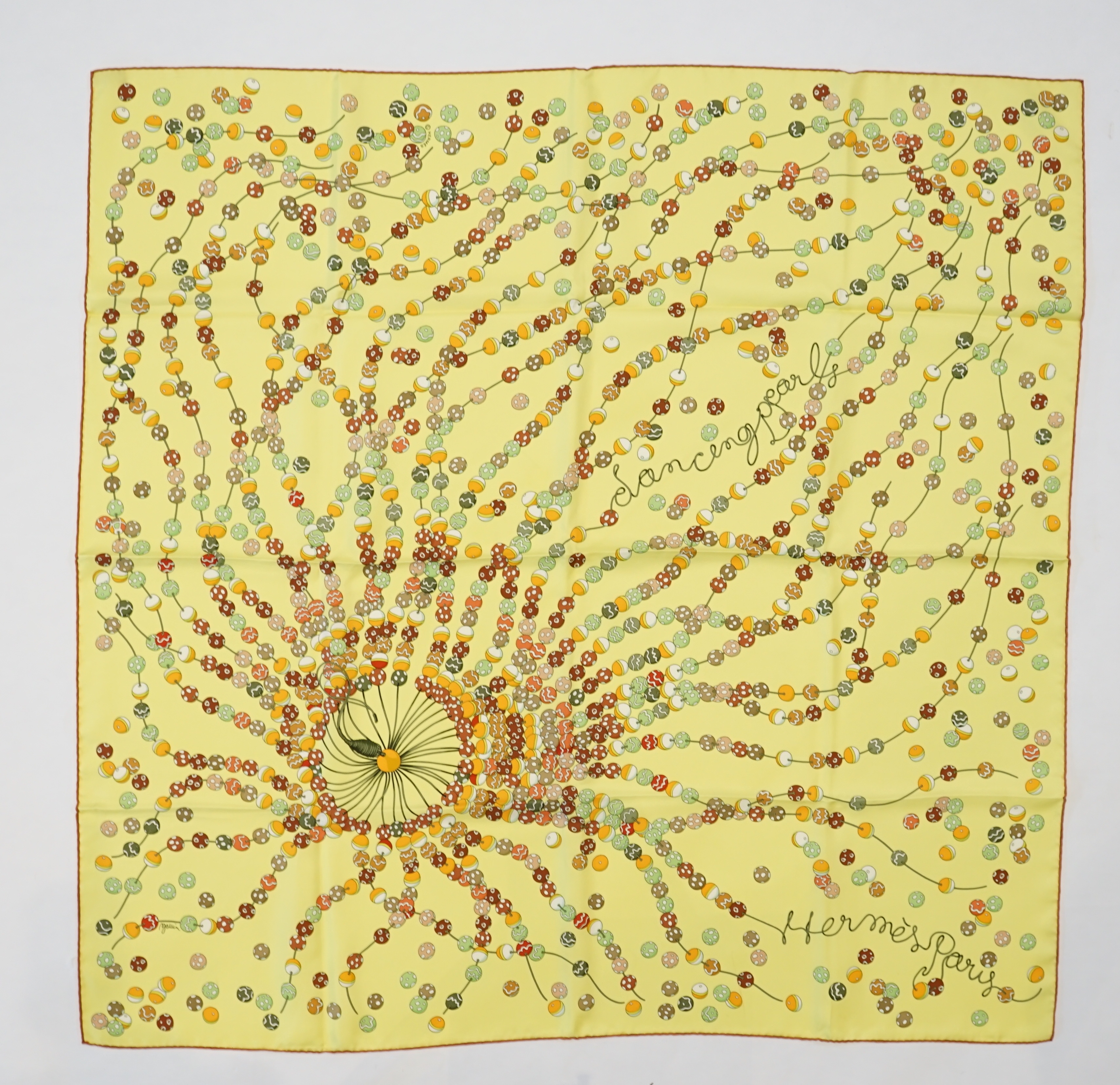 A yellow Hermès 'Dancing Pearls' silk scarf designed by Virginie Jamin, 90cm x 90cm